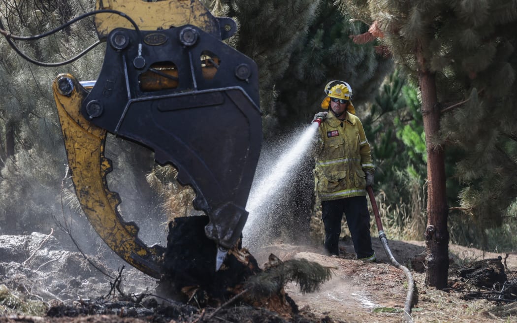 170224 CHRIS SKELTON / POOL
Firefighters continue their efforts on Saturday as they work to dampen down remaining hot spots and create a buffer zone around the 24km perimeter fire ground in Christchurch's Port Hills. Pictured Rural firefighter Aaron Kinnane (City Care firefighter)