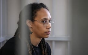 US WNBA basketball superstar Brittney Griner sits inside a defendants' cage before a hearing at the Khimki Court, outside Moscow on July 27, 2022. - Griner, a two-time Olympic gold medallist and WNBA champion, was detained at Moscow airport in February on charges of carrying in her luggage vape cartridges with cannabis oil, which could carry a 10-year prison sentence. (Photo by Alexander Zemlianichenko / POOL / AFP)