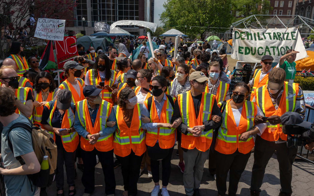 Faculty of Columbia University link arms to protect students inside threatened with suspension if they refused to voluntarily dismantle the pro-Palestinian encampment on campus on April 29, 2024 in New York City.
