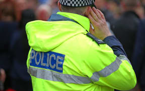 Police officer during Prince Harry's NZ tour.