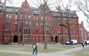CAMBRIDGE, MASSACHUSETTS - MARCH 12: Students walk through Harvard Yard on the campus of Harvard University on March 12, 2020 in Cambridge, Massachusetts. Students have been asked to move out of their dorms by March 15 due to the Coronavirus (COVID-19) risk. All classes will be moved online for the rest of the spring semester.   Maddie Meyer/Getty Images/AFP (Photo by Maddie Meyer / GETTY IMAGES NORTH AMERICA / Getty Images via AFP)