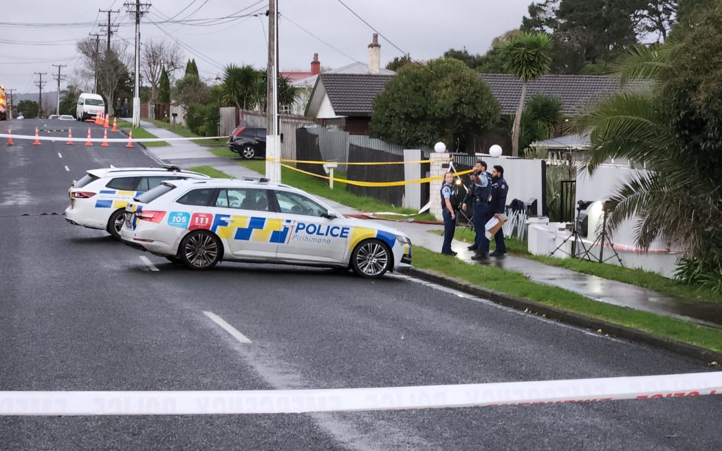 Police at the street where a woman was shot in Henderson, West Auckland.