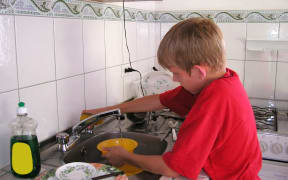 Boy doing the dishes