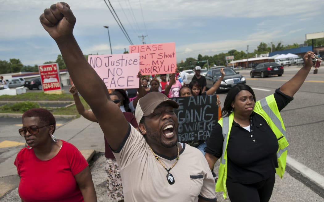 Protestors march down West Florissant Avenue in Ferguson.