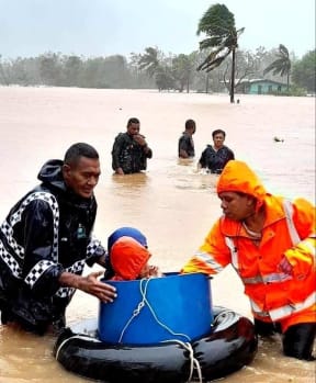 People are helped to get to safety by local police