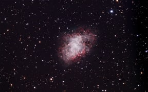 Crab nebula (M1). This is a supernova remnant, a shell of gas expanding from the explosive death of a massive star. The supernova that created this remnant was recorded by early astronomers in 1054, and was visible in daylight for 23 days. A supernova is the death of a massive star. Once it runs out of fuel for nuclear fusion the layers collapse into a central neutron star. The outer layers fall on this, ignite and rebound with an enormous amount of energy. A neutron star may have the mass of the Sun in a region just 10 kilometres across. This supernova remnant lies around 6500 light years from Earth in the constellation Taurus.