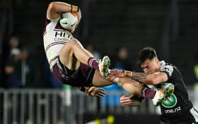 Reuben Garrick of the Sea Eagles and Warriors player Charnze Nicoll-Klokstad clash during the New Zealand Warriors v Manly Sea Eagles.