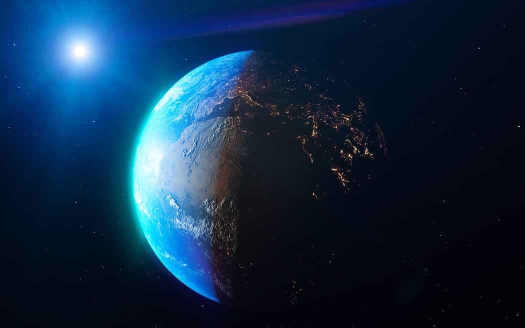 Satellite view of the Earth seen from space. The sun rising over the Europe and north Africa. Cities illuminated in the night. Sunrise
