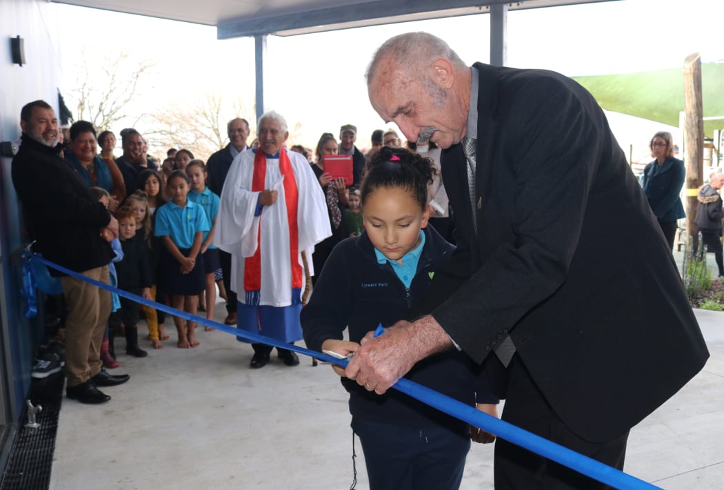 Seven-year-old Lyreena Heta helps Far North Mayor John Carter cut the ribbon for Kerikeri Primary Schools new classroom block.