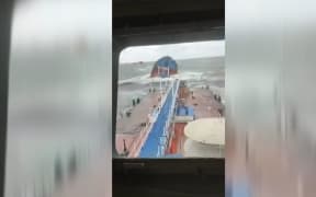 Unverified video posted on Telegram showed stormy seas and a half-submerged tanker.