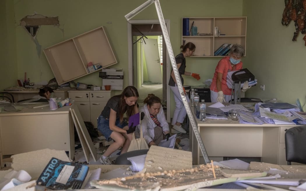 Medical personnel clear the rubble inside a heavily damaged building of Ohmatdyt Children's Hospital following a Russian missile attack in the Ukrainian capital of Kyiv on July 8, 2024, amid Russian invasion in Ukraine. Russia launched more than 40 missiles at several cities across Ukraine on July 8, 2024 in an attack that killed at least 20 people and smashed into a children's hospital in Kyiv, officials said. (Photo by Roman PILIPEY / AFP)