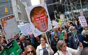 Protestors take part in the "Tax March" to call on US President Donald Trump to release his tax records on April 15, 2017 in New York.