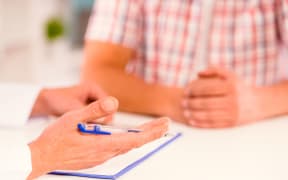 A doctor gives a male patient an update on his case (file photo)