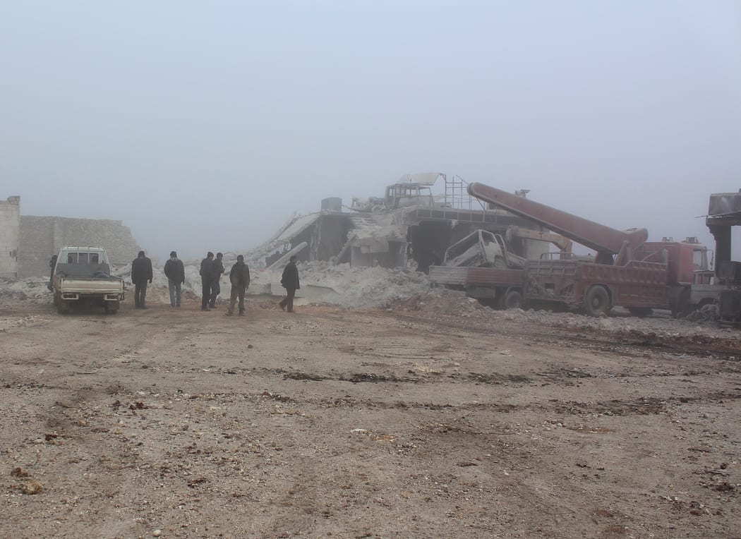 People inspect an area in Etarib district of Aleppo, Syria, after Assad Regime forces used vacuum bombs in what rebel groups say was a violation of ceasefire agreements.