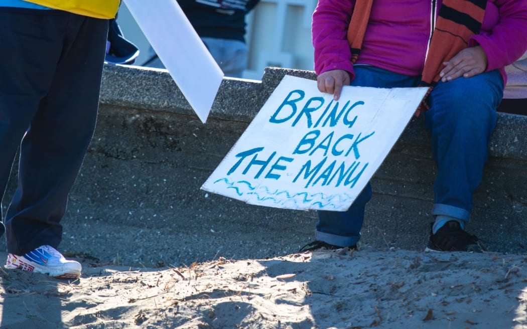 A sign calling for Petone Wharf to be saved for more manus, at a community walk on 28 April 2024.