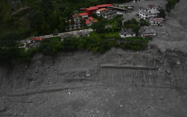 An aerial view shows Chilime Hydropower station deluged in sludge in the aftermath of flash floods at Syabrubesi in Nepal's Rasuwa district on September 3, 2026. More than 1,200 people have been killed and nearly 5,000 are missing on both sides of the China-Nepal border since the catastrophic glacial mountain collapse on August 26, according to tolls by both nations on September 3. (Photo by Prakash MATHEMA / AFP)