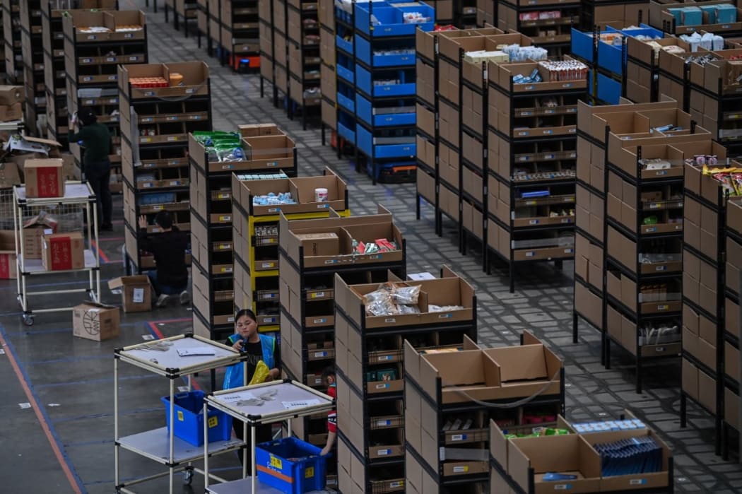 taken on November 6, 2020, employees put products in shelves in the warehouse of Cainiao Smart Logistics Network, the logistics affiliate of e-commerce giant Alibaba, in Wuxi, China's eastern Jiangsu province