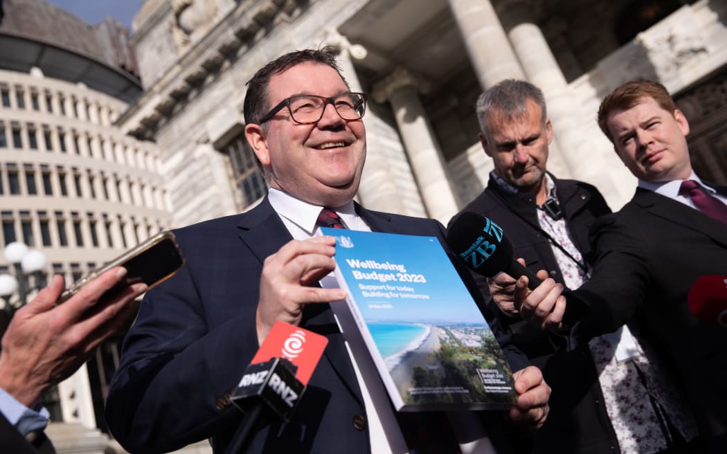 Finance minister Grant Robertson showing the cover of Budget 2023 the day before its reveal