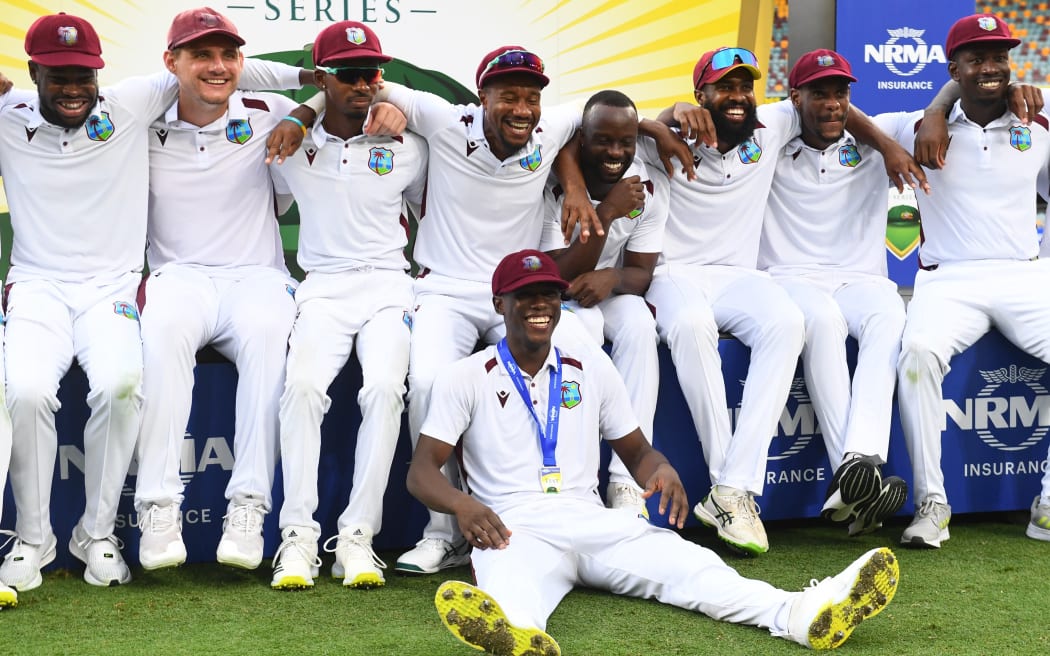 The West Indies celebrate after they beat Australia in the second test in Brisbane.