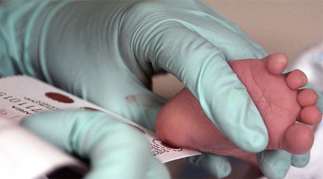 Blood is collected from a newborn for screening