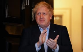 File file photo taken on 2 April 2020 of Britain's Prime Minister Boris Johnson as he participates in a national "clap for carers" to show thanks for the work of Britain's NHS workers and frontline medical staff as they battle the  coronavirus pandemic.