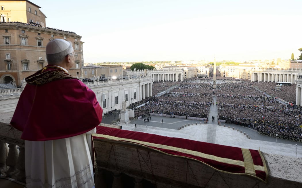 This photo taken and handout on May 7, 2025 by The Vatican Media shows Newly elected Pope Leo XIV, Robert Prevost addressing the crowd from the main central loggia balcony of the St Peter's Basilica for the first time, after the cardinals ended the conclave, in The Vatican. (Photo by Handout / VATICAN MEDIA / AFP) / RESTRICTED TO EDITORIAL USE - MANDATORY CREDIT "AFP PHOTO / VATICAN MEDIA" - NO MARKETING - NO ADVERTISING CAMPAIGNS - DISTRIBUTED AS A SERVICE TO CLIENTS