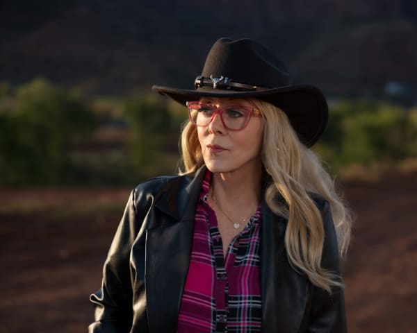 Christine Marie wears a black cowboy hat and has long blonde hair.