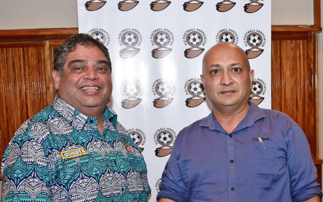 Aiyaz Mohammed Musa Umarji, on right, shakes hands with Fiji Football Association President Rajesh Patel.