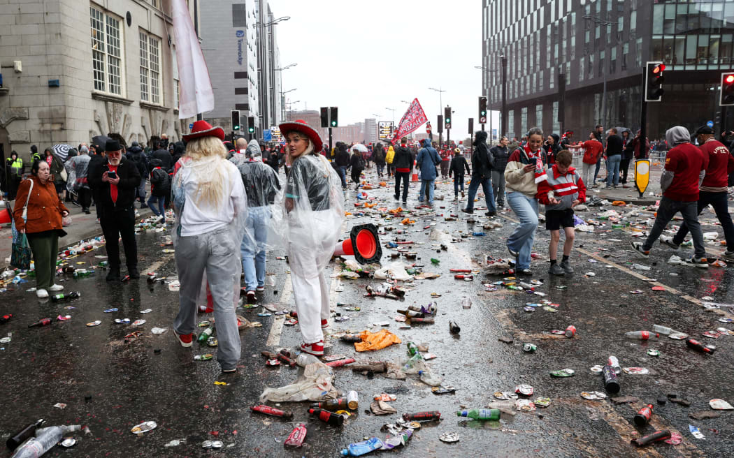 Liverpool supporters leave at the end of the open-top bus victory parade for Liverpool's Premier League title win, in Liverpool, north-west England on 26 May 2025, after a car hit pedestrians at the parade.