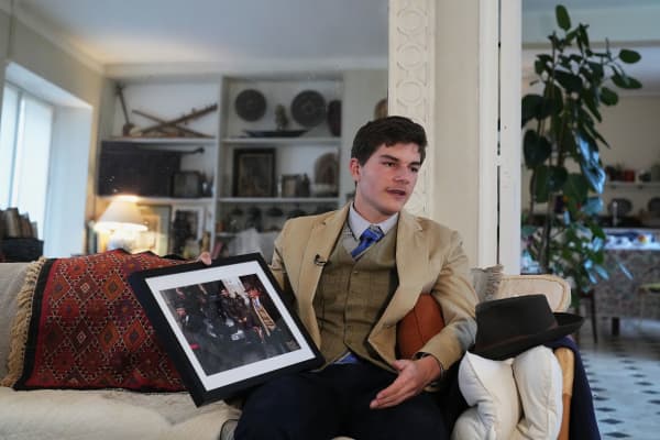 Pedro Elias Garzon Delvaux holds an Associated Press photo of him taken outside the Louvre on the day of the crown jewels heist in Rambouillet, south of Paris.