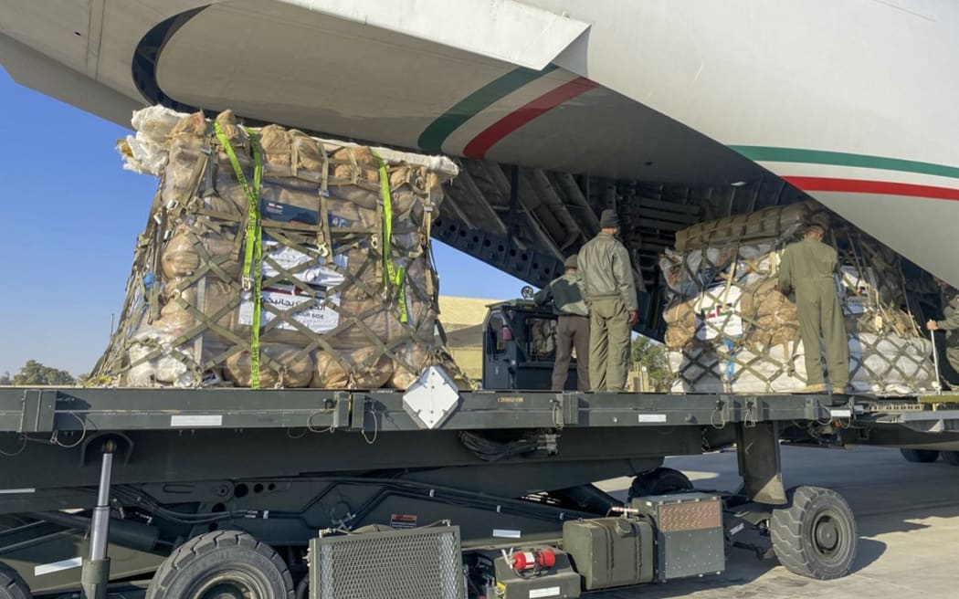 A handout photo released by Kuwaiti Defence Ministry on December 7, 2023, shows humanitarian aid bound for Egypt and then onto the Gaza Strip, as it is loaded into a Kuwaiti military aicraft at Kuwait's International Airport in Kuwait City, amid continuing battles between Israel and the Palestinian group Hamas. (Photo by KUWAITI DEFENCE MINISTRY / AFP) / RESTRICTED TO EDITORIAL USE - MANDATORY CREDIT "AFP PHOTO /  KUWAITI DEFENCE MINISTRY " - NO MARKETING NO ADVERTISING CAMPAIGNS - DISTRIBUTED AS A SERVICE TO CLIENTS