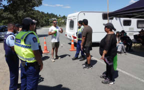 Police talking to protesters blocking access to a boat ramp at Taipā in the Far North.