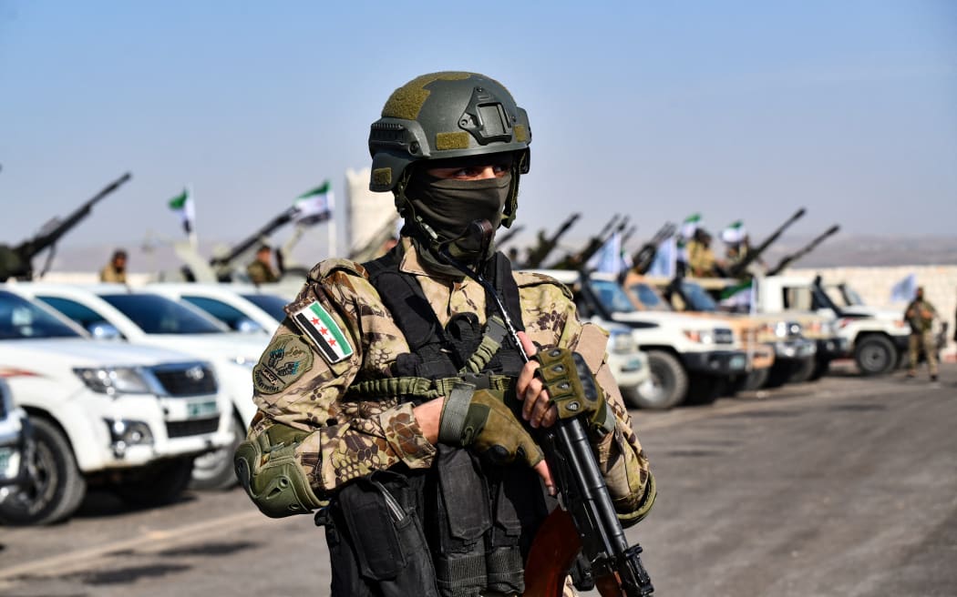 A Turkey-backed Syrian fighter takes part in a military parade in the countryside of the northwestern city of Afrin, in the rebel-held part of Aleppo province, on 1 June 2022.
