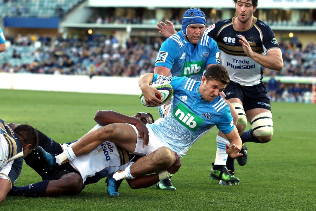 Blues player Matt Duffie scores through Tevita Kuridrani in Canberra.