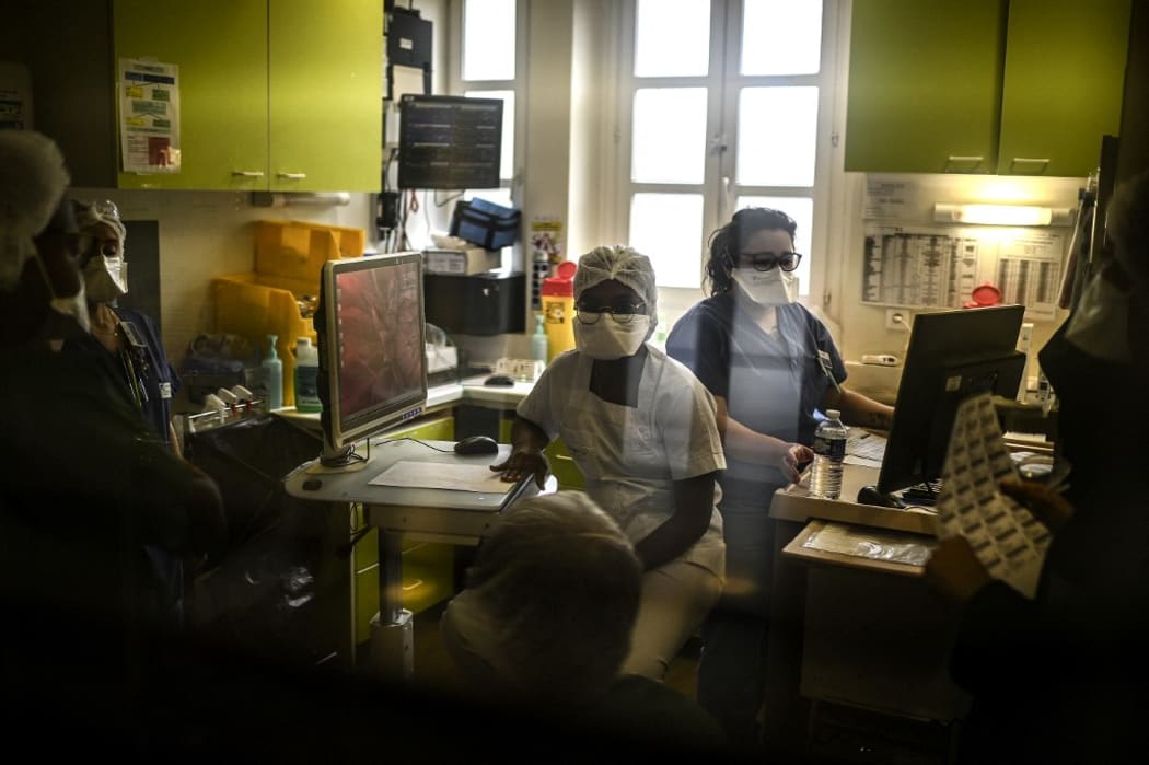 Members of the medical staff work at the pneumology unit of the AP-HP Cochin hospital, in Paris on March 18, 2021 as the number of people hospitalised with the Covid-19 is on the rise in the French capital.