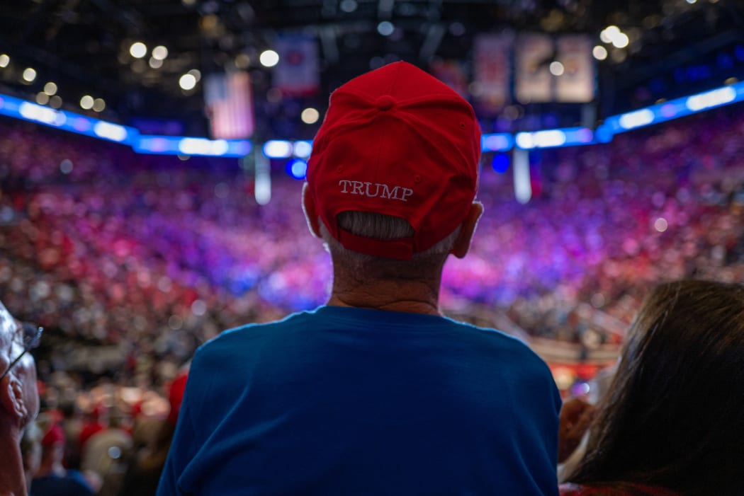 UNIONDALE, NEW YORK - SEPTEMBER 18: Supporters watch and cheer as former President Donald Trump speaks at an evening rally in Uniondale on Long Island on September 18, 2024 in Uniondale, New York. Security at the event is tight following the arrest of an individual over the weekend hiding with a gun at Trump’s Florida golf course.   Spencer Platt/Getty Images/AFP (Photo by SPENCER PLATT / GETTY IMAGES NORTH AMERICA / Getty Images via AFP)