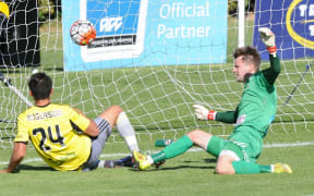 Wellington Phoenix's Logan Rogerson scores a goal past Hawkes Bay United keeper Josh Hill in the ASB Premiership match, Hawkes Bay United vs Wellington Phoenix, Bluewater Stadium, Napier, Sunday, December 13, 2015. Copyright photo: Kerry Marshall / www.photosport.nz