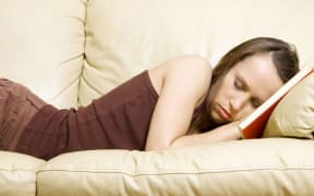 Woman asleep on sofa (stock image)