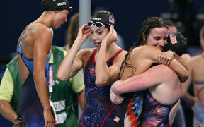 Team USA (L to R) Torri Huske, Regan Smith, Lilly King and Gretchen Walsh celebrate after winning  the final of the women's 4x100m medley relay at the Paris Olympics.