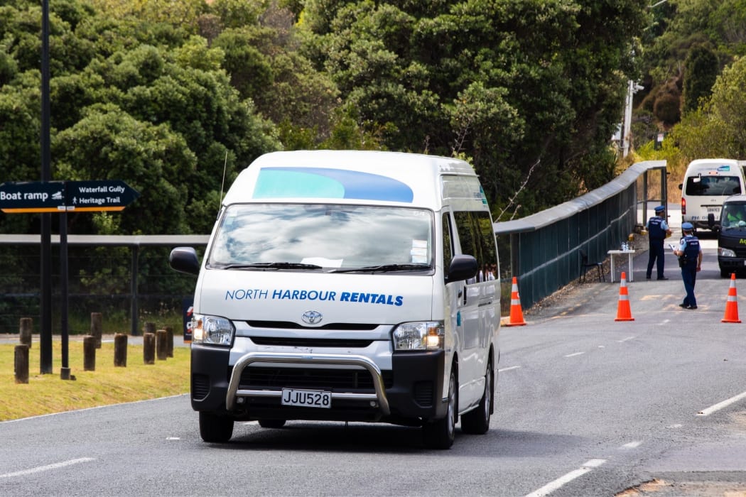 The first evacuees leave quarantine at the Whangaparāoa military base.