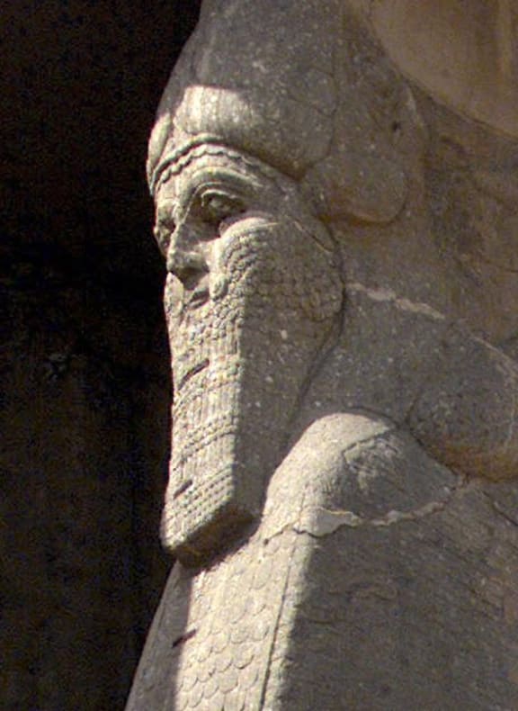 The ancient statue of a winged bull with a human face, an indication of strength in the Assyrian civilization, at the archaeological site of Nimrud,