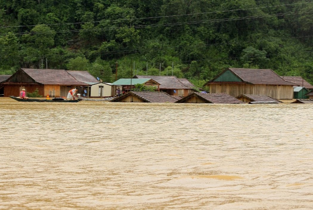This picture taken on October 8, 2020 and released on October 9, 2020 by the Vietnam News Agency shows houses inundated by floodwaters following heavy rainfall in Central Vietnam's Quang Binh province.
