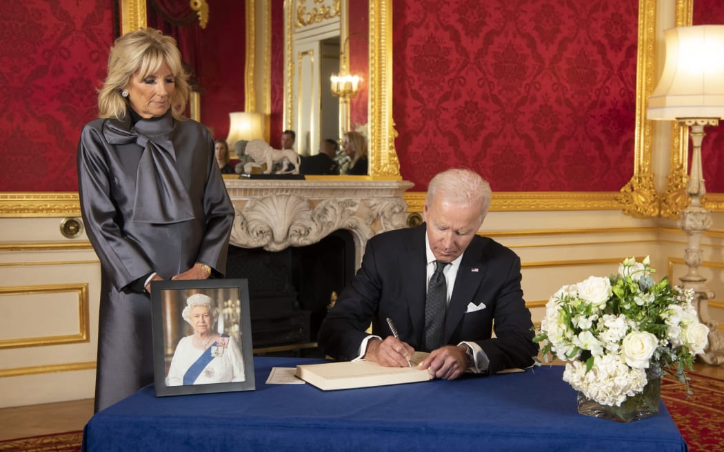 US President Joe Biden and First Lady Jill Biden, sign a book of condolence at Lancaster House in London on September 18, 2022 following the death of Queen Elizabeth II on September 8.