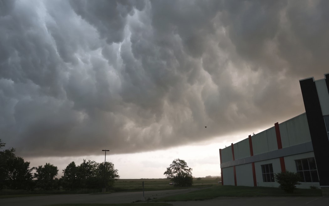 Severe storm clouds move across the northwest edge of Davenport, Iowa on Friday, May 24, 2024. Several tornadoes were reported in Iowa and Illinois as storms downed power lines and trees on Friday, just after a deadly twister devastated one small town.(Roy Dabner/Quad City Times via AP)