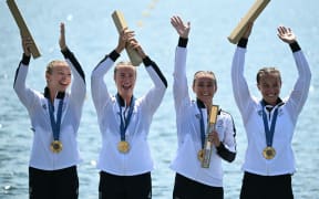 (From R) New Zealand's gold medallists Lisa Carrington, Alicia Hoskin, Olivia Brett and Tara Vaughan celebrate on the podium during the medal ceremony after the women's kayak four 500m final of the canoe sprint competition at Vaires-sur-Marne Nautical Stadium in Vaires-sur-Marne during the Paris 2024 Olympic Games on August 8, 2024. (Photo by Bertrand GUAY / AFP)