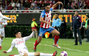 Gael Sandoval of Guadalajara, right, vies for the ball with Vladimir Loroña of Tijuana, left.