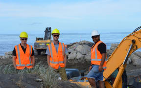 From left, Cashmore Contracting managing director Rob Cashmore, Horizons Regional Council project engineer Dougal Ross, and Kahurangi Simon, of Te Mata Pūau, at works to repair Whanganui's North Mole.