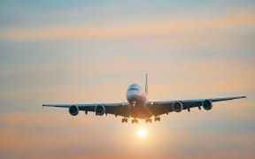 Airplane in the sky at sunset