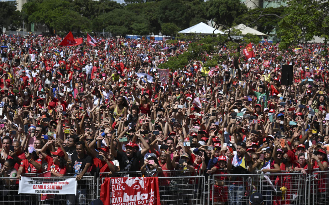 Supporters of Brazil's President-elect Luiz Inacio Lula da Silva cheer as he arrives at the National Congress for his inauguration ceremony, in Brasilia, on January 1, 2023.
