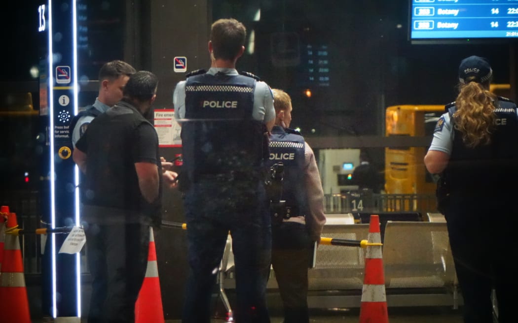 Police at the scene of an assault at a bus station in Manukau.